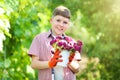 Boy holding bucket with flowers Royalty Free Stock Photo