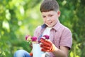 Boy holding bucket with flowers Royalty Free Stock Photo