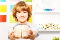 Young boy holding cerebrum model at the classroom