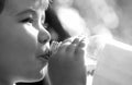 Young boy holding drink fresh water bottle. A child drinks water from a bottle, baby health. Portrait of a boy with a Royalty Free Stock Photo