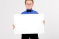 Young boy holding an empty advertising card