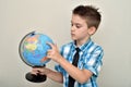 Young boy holding and examining the globe Royalty Free Stock Photo
