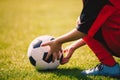 Young boy holding football ball. Soccer sports background