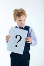 Young boy holding question mark sign isolated on white background. Royalty Free Stock Photo