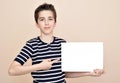 Young boy holding blank white board