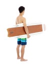 Young boy holding a surfboard over white background Royalty Free Stock Photo