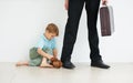 Dont go.... A young boy holding a teddybear and looking sad because his dad has to go to work. Royalty Free Stock Photo