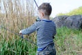 Young boy holding up his fishing rod and reel Royalty Free Stock Photo