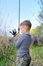 Young boy holding up his fishing rod and reel Royalty Free Stock Photo