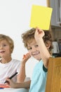 Young boy holding up yellow card