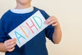 Young boy holds ADHD text Royalty Free Stock Photo