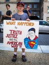 A Young Child Holds a Protest Sign at a Demonstration Against President Donald Trump