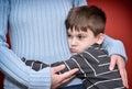 Young boy hugging his mother