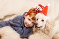 Young boy hugs a big dog in Christmas hats. Celebrating new year, christmas Royalty Free Stock Photo