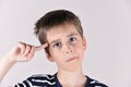 Young boy with the index finger on his head Royalty Free Stock Photo