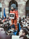 Young boy with Je suis Charlie paperboard sign on his father's