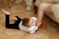 A young boy is jealous, holds his mother by the leg and does not let her go on a date. Child`s jealousy, single-parent families, Royalty Free Stock Photo