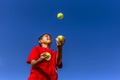 Young boy juggles balls. Royalty Free Stock Photo