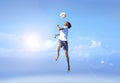 Young boy in a jump, football player doing amazing makes a headbutt a background of blue sky Royalty Free Stock Photo