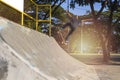 Young boy jump on ramp with skateboard outdoor