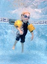 Young boy jumping into a swimming pool Royalty Free Stock Photo