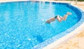 Young boy jumping into swimming pool Royalty Free Stock Photo