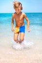 Young boy jumping on the water at the sea Royalty Free Stock Photo