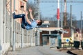 A young boy jumps somersault on the street. Royalty Free Stock Photo