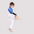 Young boy kickboxing fighter isolated on white Royalty Free Stock Photo