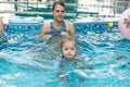 Young boy kid child eight years old splashing in swimming pool having fun leisure activity open arms Royalty Free Stock Photo