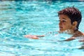 Young boy kid child eight years old swimming in pool having fun leisure activity Royalty Free Stock Photo