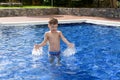 Boy plaiyng in swimming pool Royalty Free Stock Photo