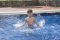 Boy plaiyng in swimming pool Royalty Free Stock Photo