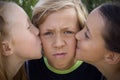 Young boy kissed by two girls Royalty Free Stock Photo