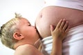 Young boy is kissing the belly