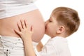 Young boy is kissing the pregnant woman Royalty Free Stock Photo