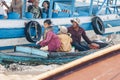 Young boy with large python snake on the wooden boat at the Tonle Sap lake in Cambodia 2019-12-27. The floating village Royalty Free Stock Photo