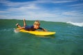 Boy lay on surf board and start paddling to catch the wave Royalty Free Stock Photo