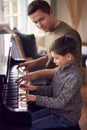 Young Boy Learning To Play Piano Having Lesson From Male Teacher Royalty Free Stock Photo