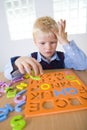 Young boy with letters jigsaw Royalty Free Stock Photo