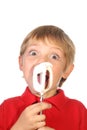 Young boy licking beaters Royalty Free Stock Photo