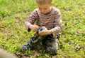 Young boy lighting a fire outdoors Royalty Free Stock Photo