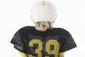 Young boy with long blonde hair in American football uniform Royalty Free Stock Photo