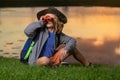 Young boy looking through binoculars. Boy traveler with backpack in a summer day. Portrait of a little boy exploring Royalty Free Stock Photo