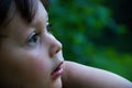Young boy looking in a different direction from the camera, lost in thought Royalty Free Stock Photo