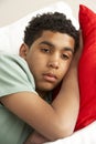 Young Boy Looking Sad On Sofa Royalty Free Stock Photo