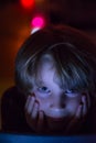 Young boy looking at tablet at night