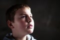 Young boy looking up with hope in his eyes Royalty Free Stock Photo