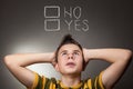 Young boy looking up at Yes and No Royalty Free Stock Photo