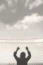 Young boy looks out from the net towards freedom Royalty Free Stock Photo